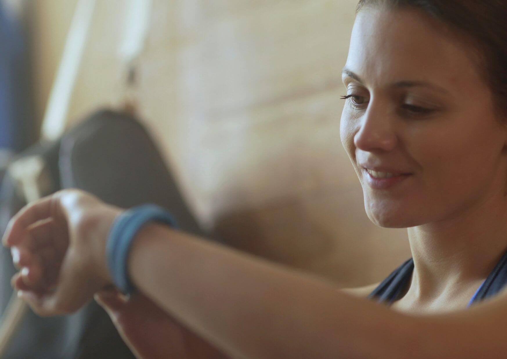 Woman looks at her fitness tracker